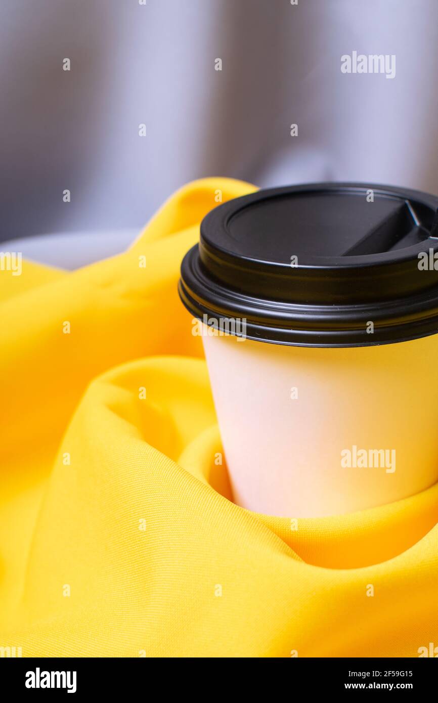 Mockup of coffee paper cup on grey and yellow background. Color 2021 ...