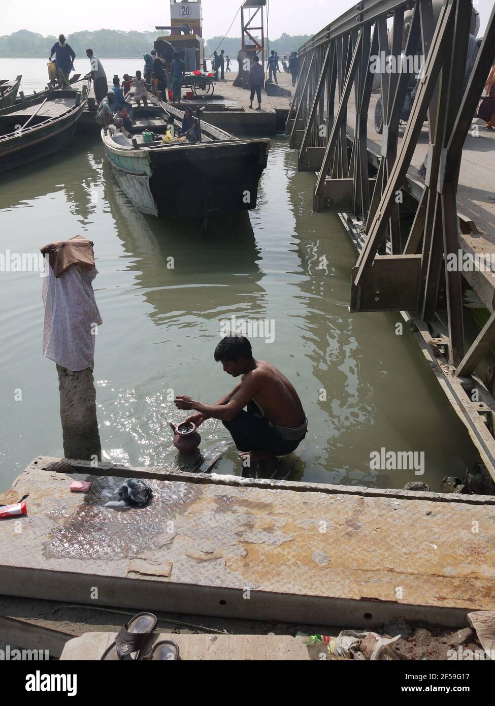 A man washes in a river in Bangladesh Stock Photo