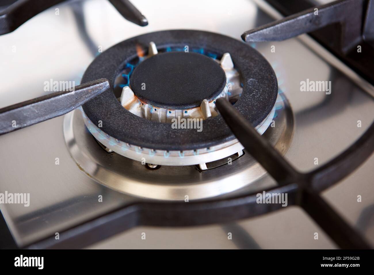 Close up portrait of gas stove top burner with flame Stock Photo Alamy
