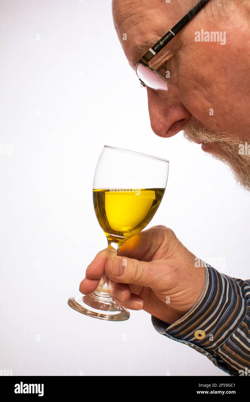 Tester checking the odour and taste of olive oil Stock Photo