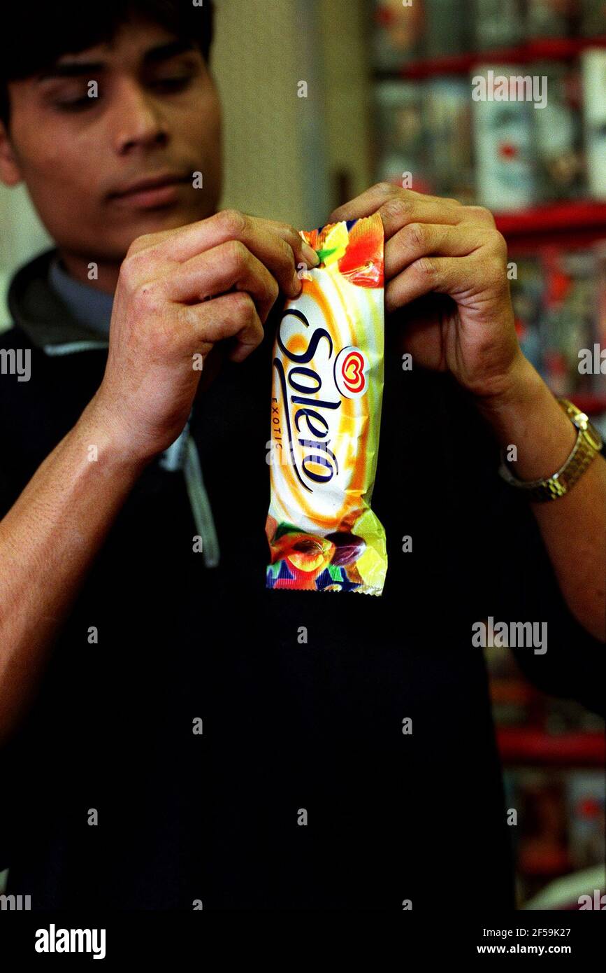 SAMPLING A SOLERO, MADE BY WALL'S ICE CREAM  MAY 1999 WHO STIPULATE THAT OTHER BRANDS MUST NOT BE PLACED IN THEIR FREEZERS Stock Photo