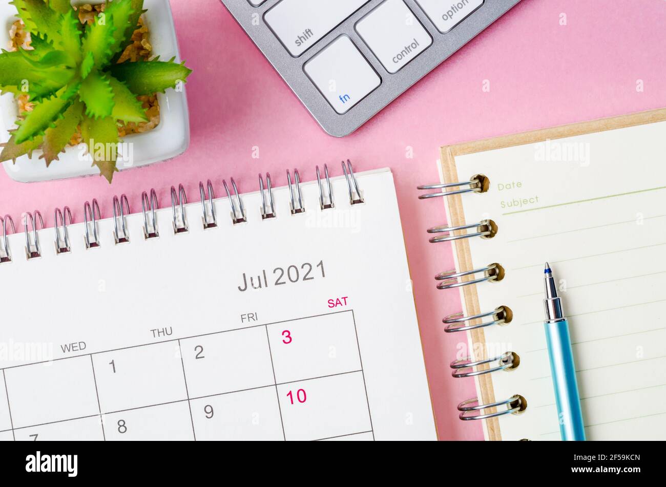 July 2021 calendar with note book on pink background Stock Photo - Alamy