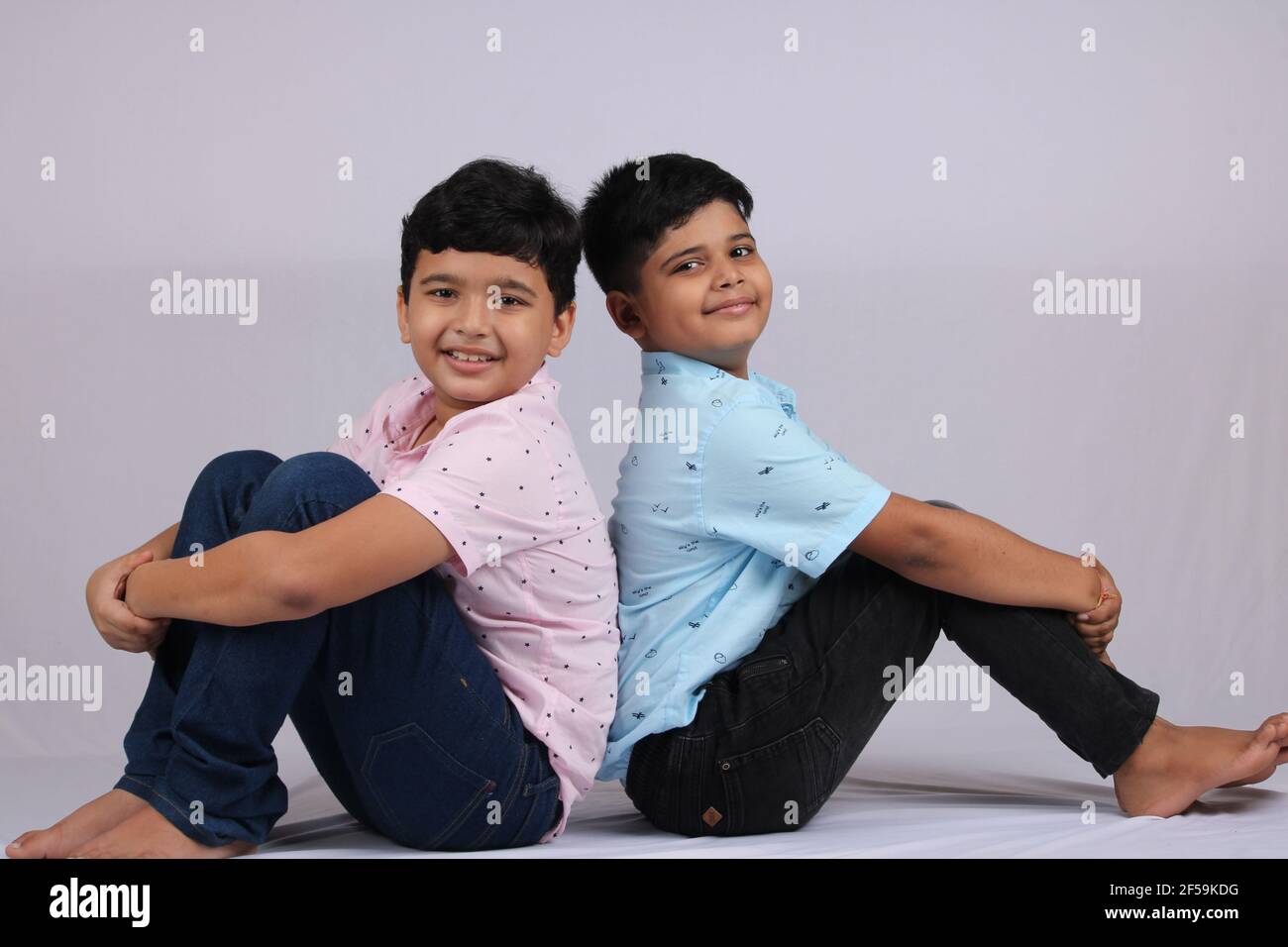 cheerful indian siblings hugging and posing for a photo. Stock Photo