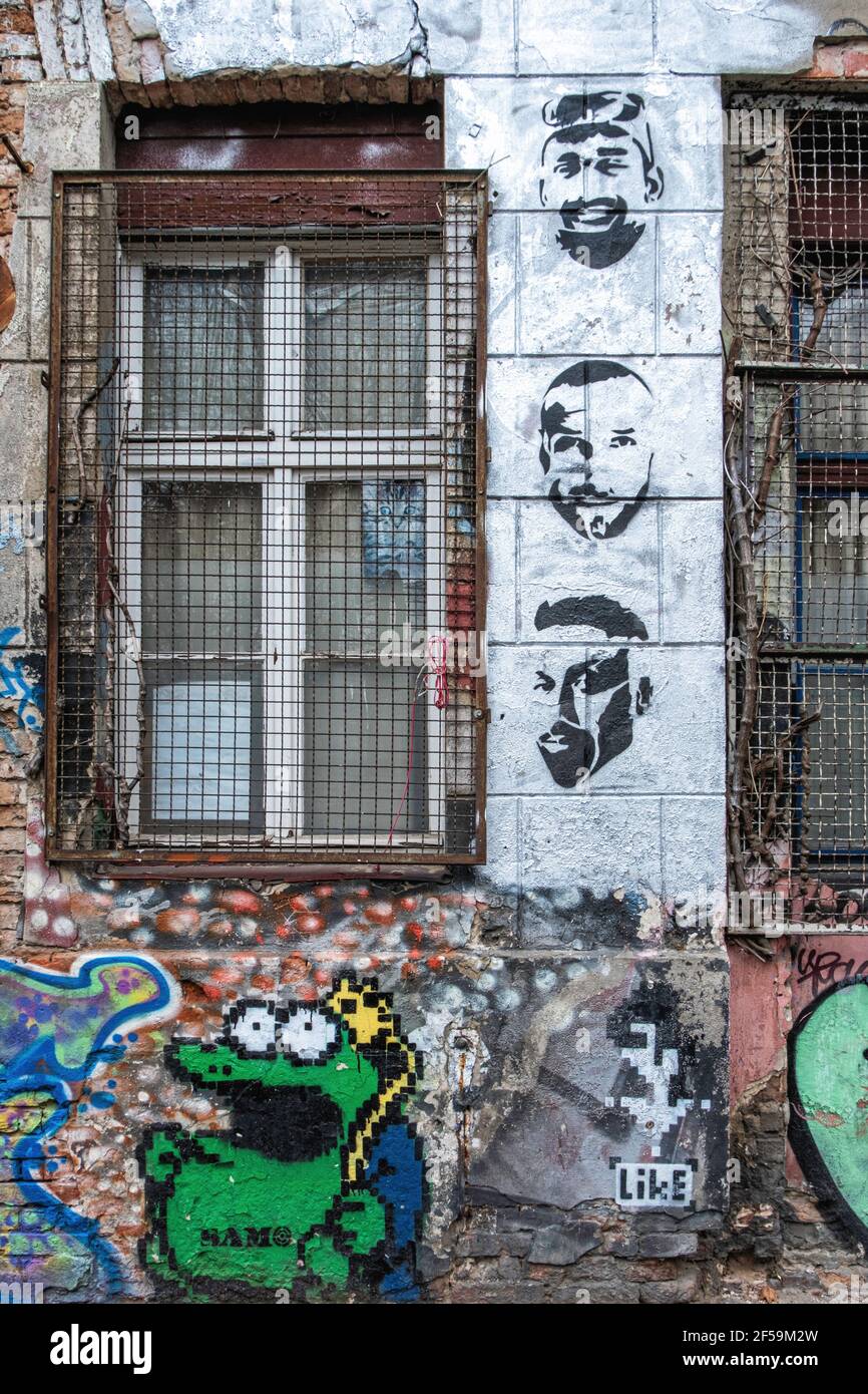 .Old squat building detail, weathered wall, graffiti, urban art, rusty burgalr bars. Linien strasse 206, Mitte, Berlin Stock Photo