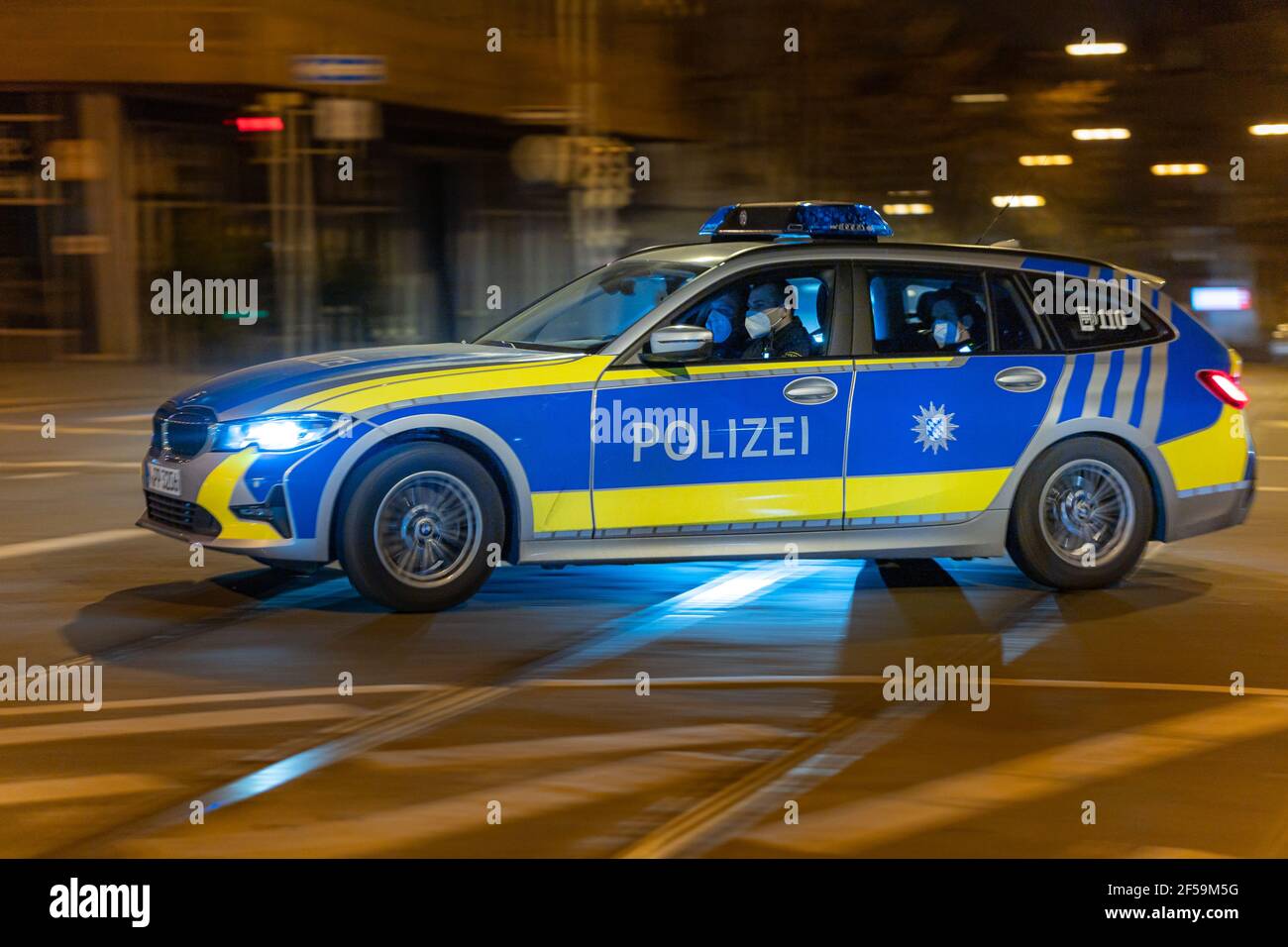 NUREMBERG, GERMANY Mar 25, 2021 Blue police car with cops inside is