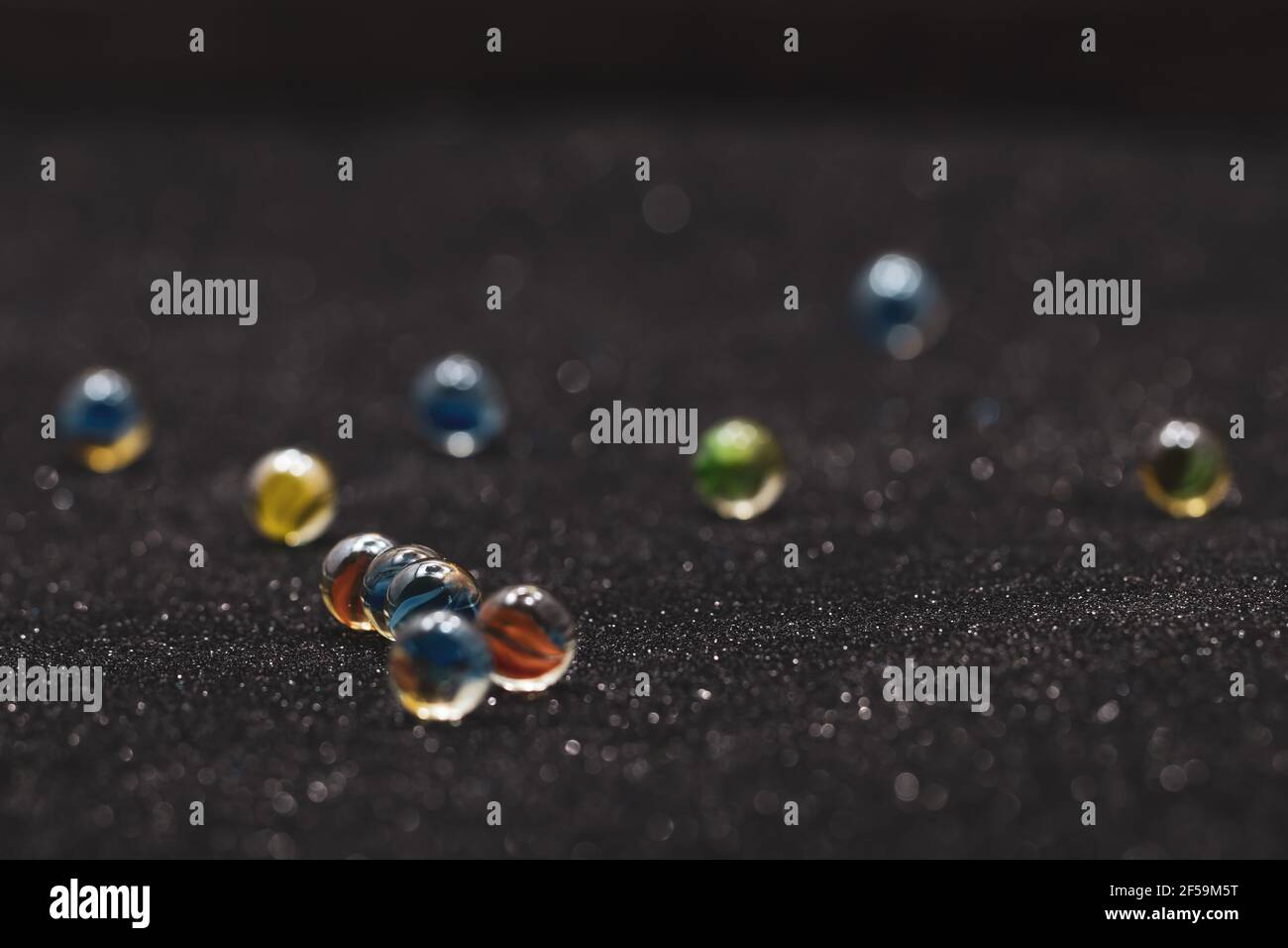 Group og glass marbles on dark surface Stock Photo