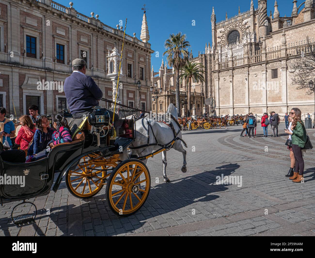 A horse and carriage taking tourists on a tour of the city centre in Seville Spain. Stock Photo