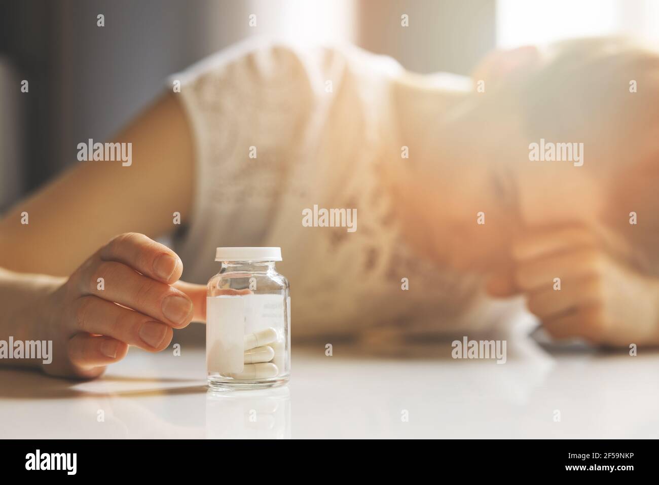 sad depressed young woman reaching for antidepressants. anxiety, fatigue and nervousness Stock Photo