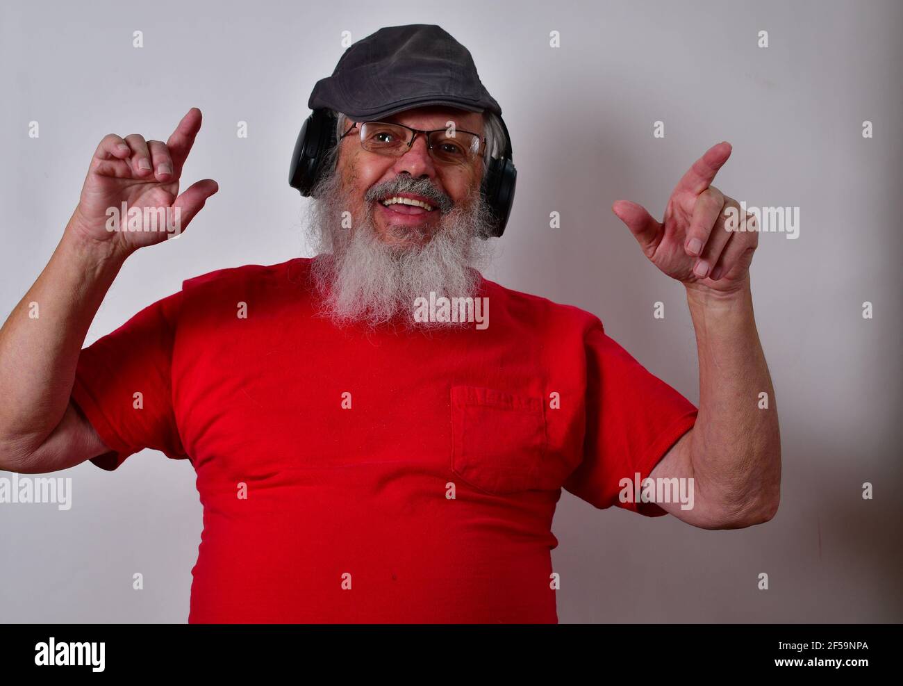 Caucasian male listening to music on headphones and making funny ...