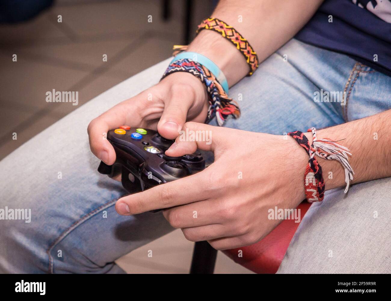 Belarus, Minsk region - September 22, 2017: The guy's hands are holding a joystick xbox and playing a console, close-up. Stock Photo