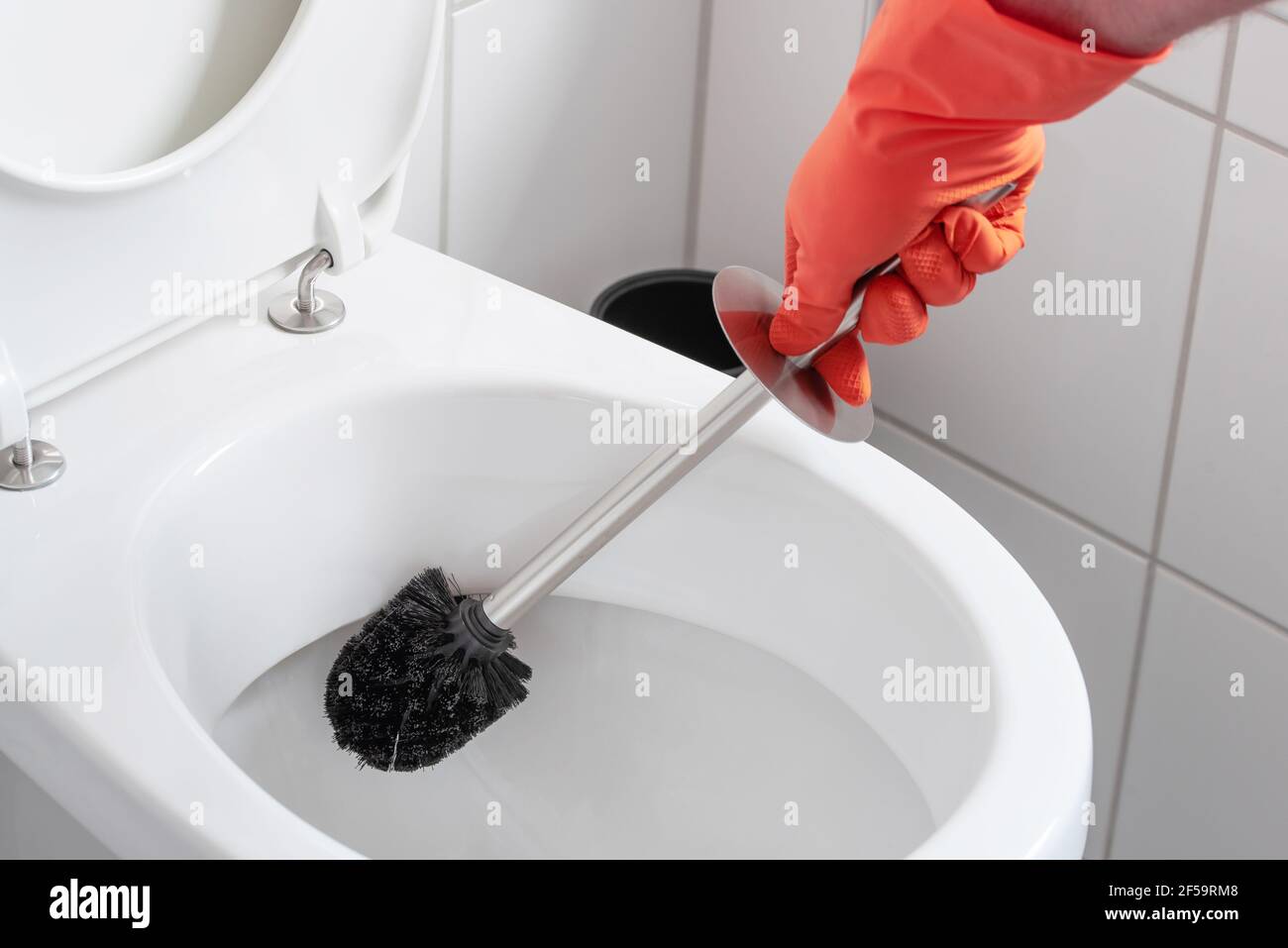 Person Wearing Rubber Gloves Cleaning Toilet Bowl With Toilet Brush Stock Photo Alamy