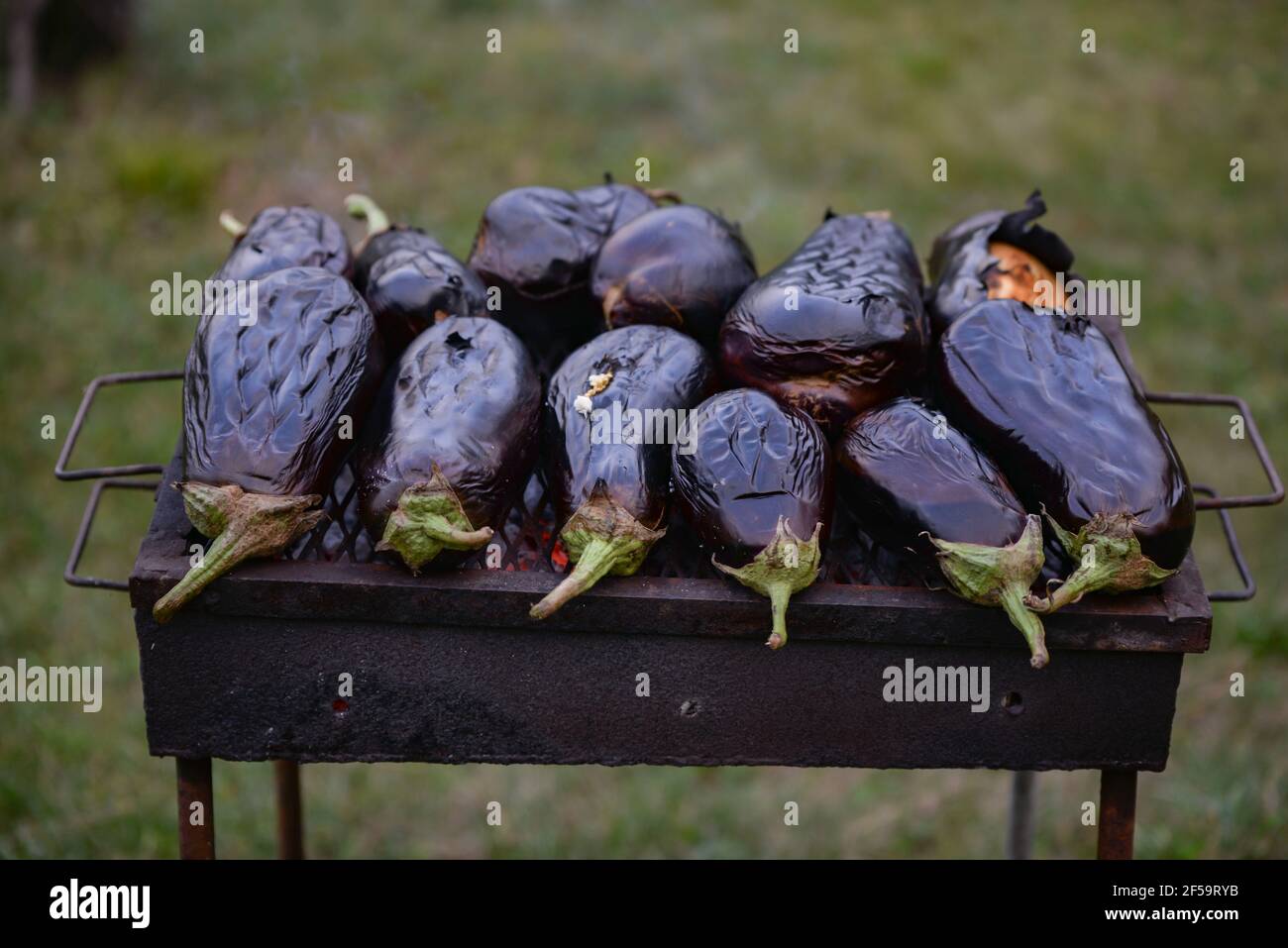 Process of grilling whole eggplants on the brazier Stock Photo Alamy