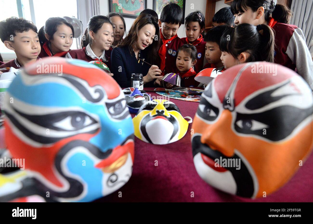 HANDAN, CHINA - MARCH 25, 2021 - Teachers and students of a primary school draw a theatrical mask in Handan, north China's Hebei province, March 25, 2021. March 27th is World Theatre Day. (Photo by Hao Qunying / Costfoto/Sipa USA) Stock Photo