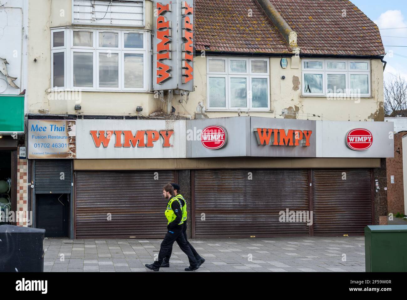 Closed Wimpy restaurant in Southend on Sea, Essex, UK. Shutters down. Decaying building, during COVID 19 Coronavirus lockdown. Patrolling officers Stock Photo