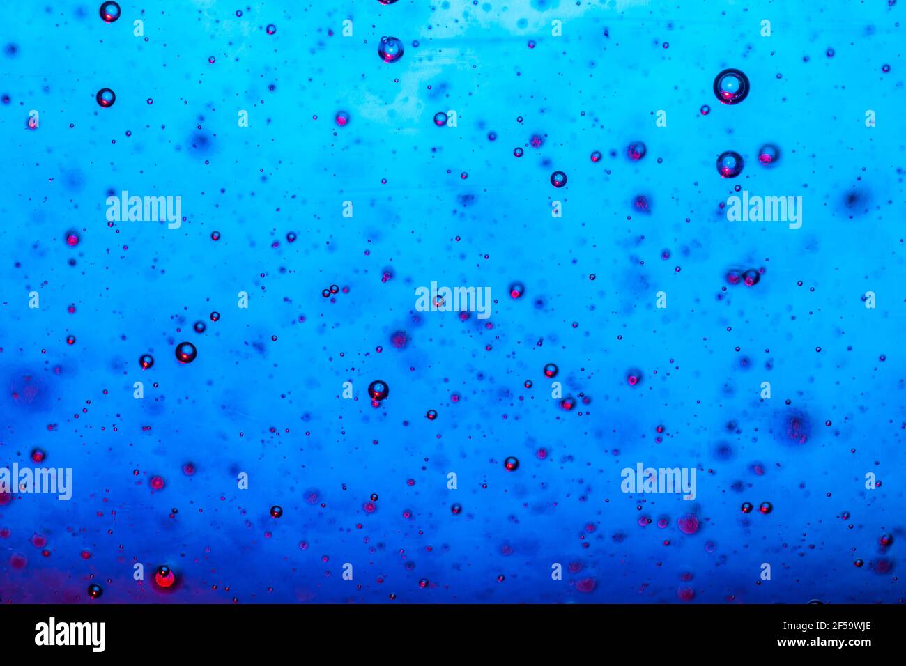 Large beautiful Oxygen bubbles underwater on a blue background macro ...