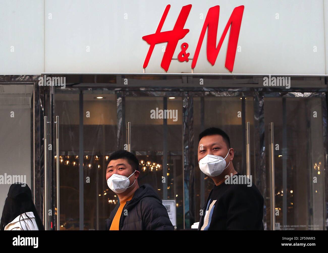 Beijing, China. 25th Mar, 2021. Chinese walk past H&M's flagship store in  Beijing on Thursday, March 25, 2021. The fashion retailer H&M is facing a  potential boycott in China, it's fastest growing