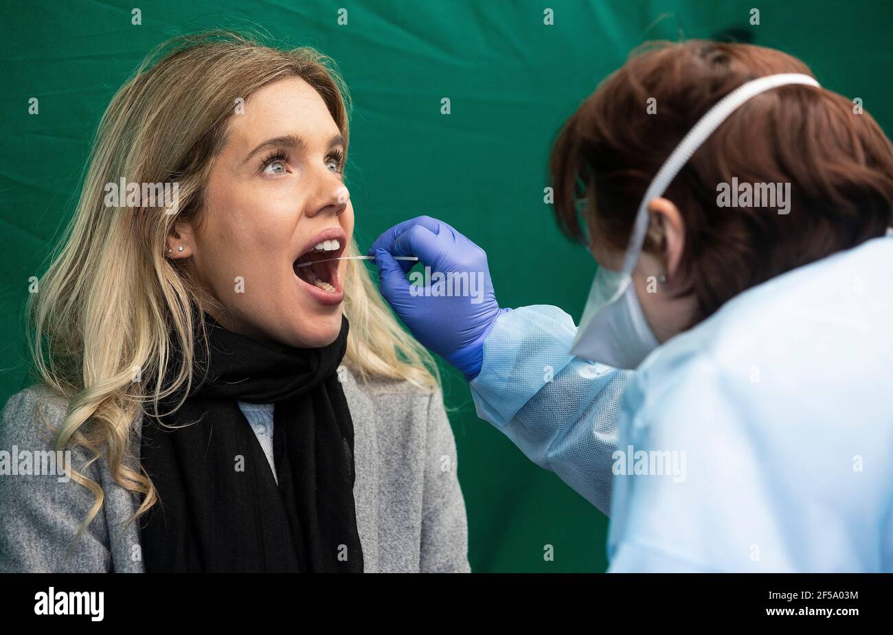 Amanda Kenny receives a swab at a walk-in test centre on the grounds of Grangegorman Primary Care Centre in Dublin as a number of centres have opened in areas where there is a high rate of Covid-19 transmission. The public does not need to get a GP referral and all tests will be free under the new initiative. Picture date: Thursday March 25, 2021. Stock Photo