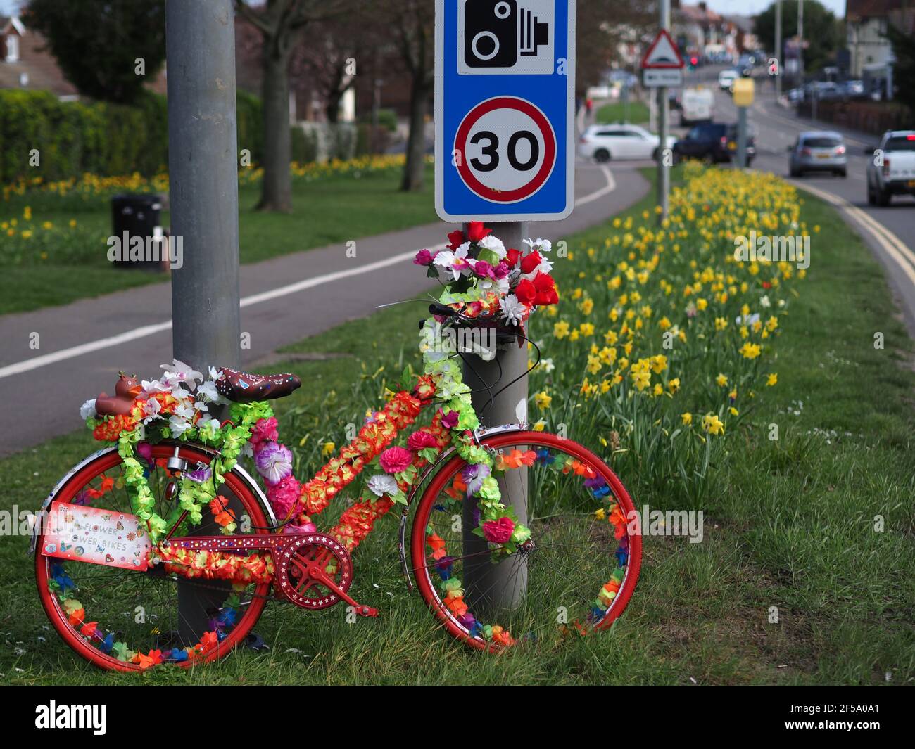 Rainham, Kent, UK. 25th Mar, 2021. A mystery artist has created some stunning 'Flower Power Bikes' around Rainham in Kent - which are bikes that have been artistically decorated with flowers to bring joy to people during lockdown. Credit: James Bell/Alamy Live News Stock Photo