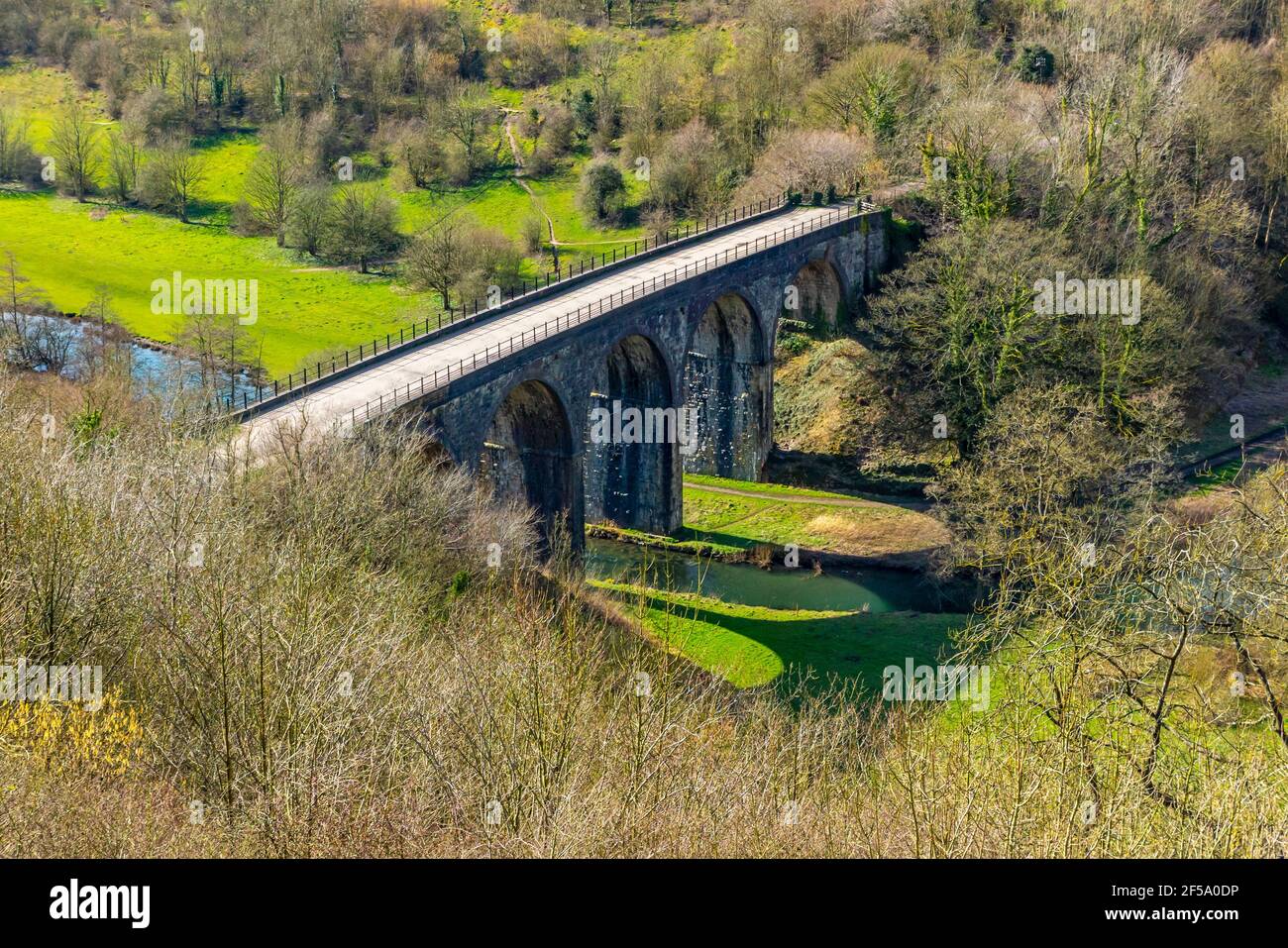 Early spring sunshine at Monsal Head a popular viewpoint in the Peak District National Park Derbyshire England UK with Monsal Viaduct in foreground. Stock Photo