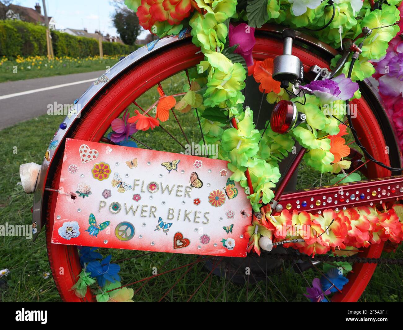 Rainham, Kent, UK. 25th March 2021. A mystery artist has created some stunning  'Flower Power Bikes' around Rainham in Kent - which are bikes that have been artistically decorated with flowers to bring joy to people during lockdown. Credit: James Bell/Alamy Live News Stock Photo
