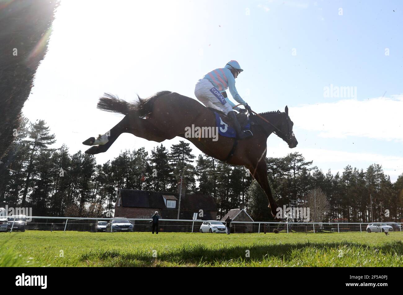 Rock On Rocco ridden by Tom Scudamore clears a fence on the first lap before winning the Join racingtv.com Novices' Handicap Chase at Ludlow Racecourse. Picture date: Thursday March 25, 2021. Stock Photo