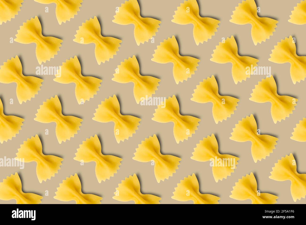 Italian pasta pattern on a light brown background. Top view. Stock Photo