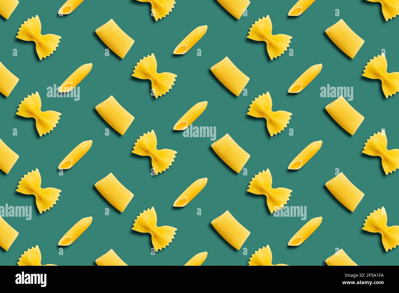 Italian pasta pattern on a green background. Top view. Stock Photo