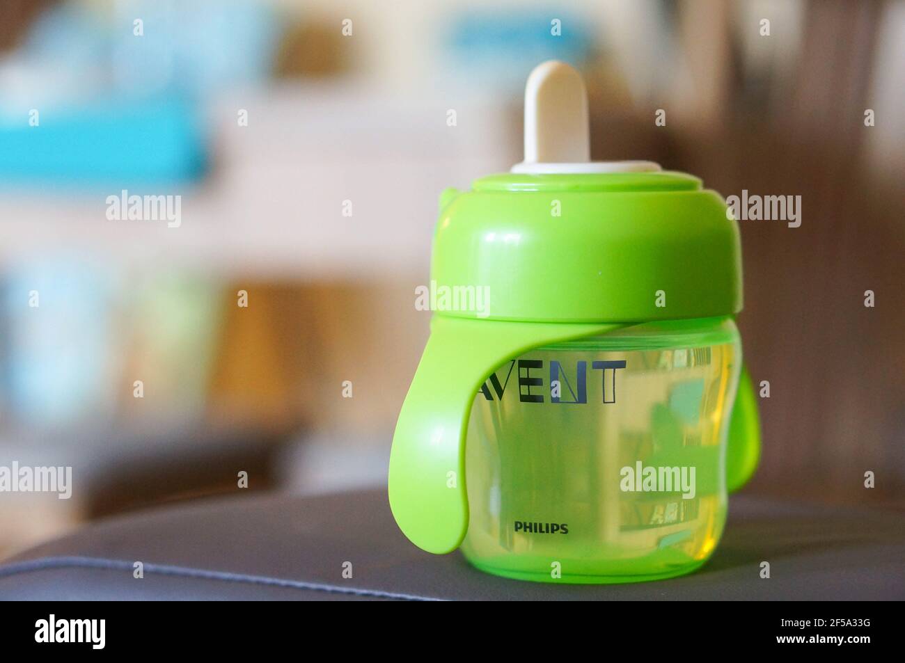 POZNAN, POLAND - Oct 24, 2015: Green plastic baby drinking bottle from Philips Avent Stock Photo