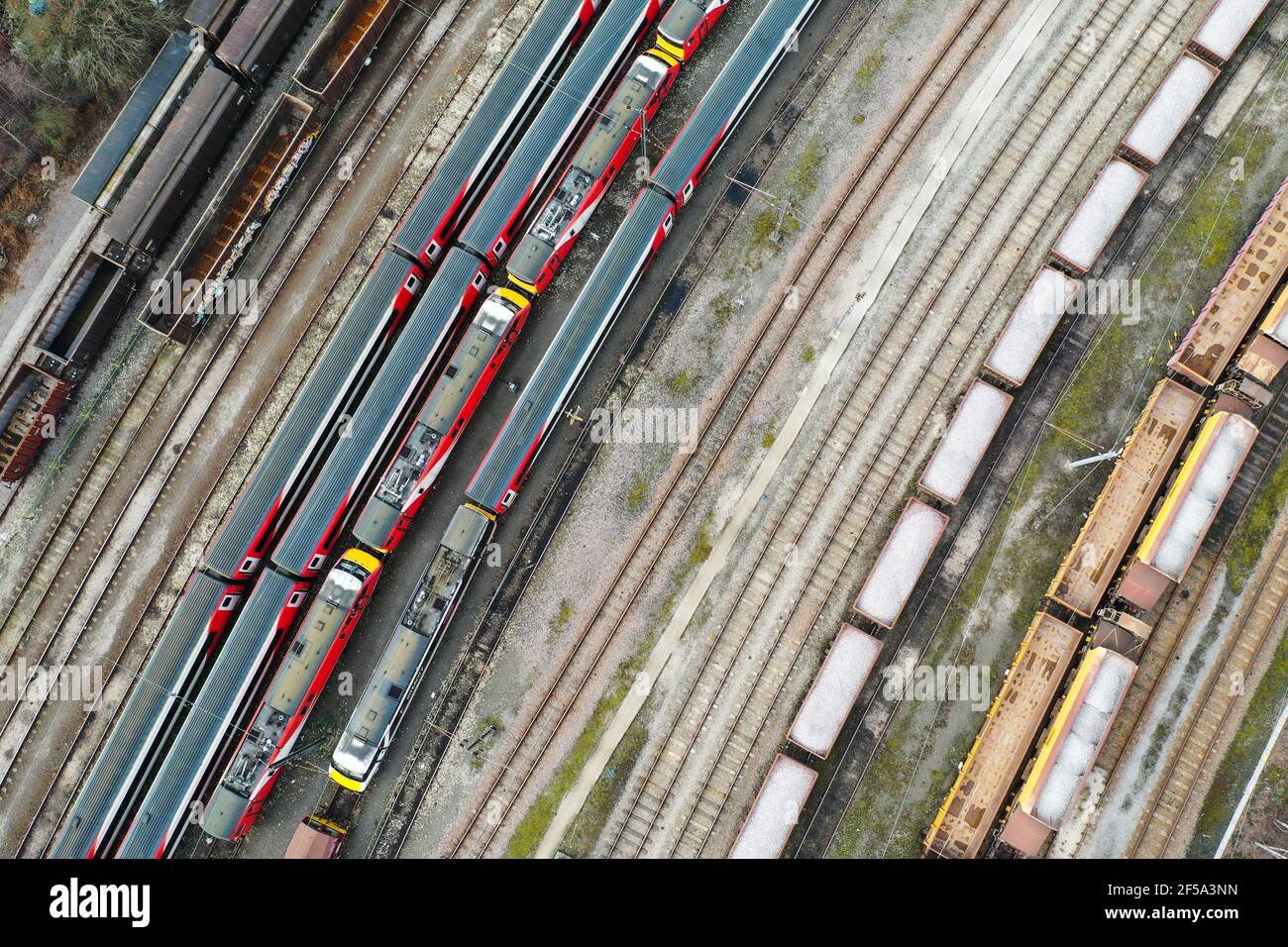 An aerial birds eye view of trains, carriages and trucks stabled in a UK freight railway sidings with copy space Stock Photo
