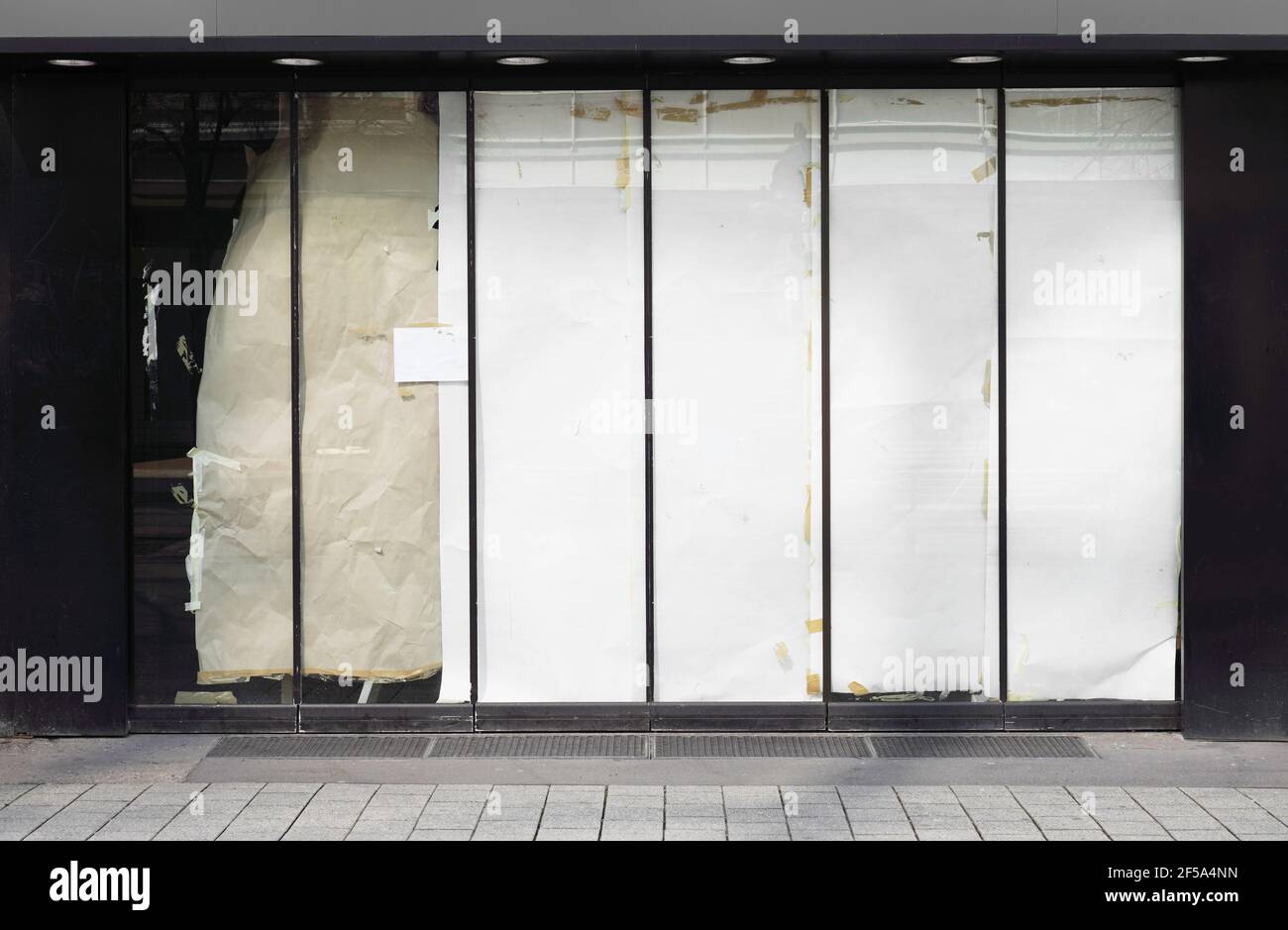 closed or empty shop or store storefront with blocked windows Stock Photo