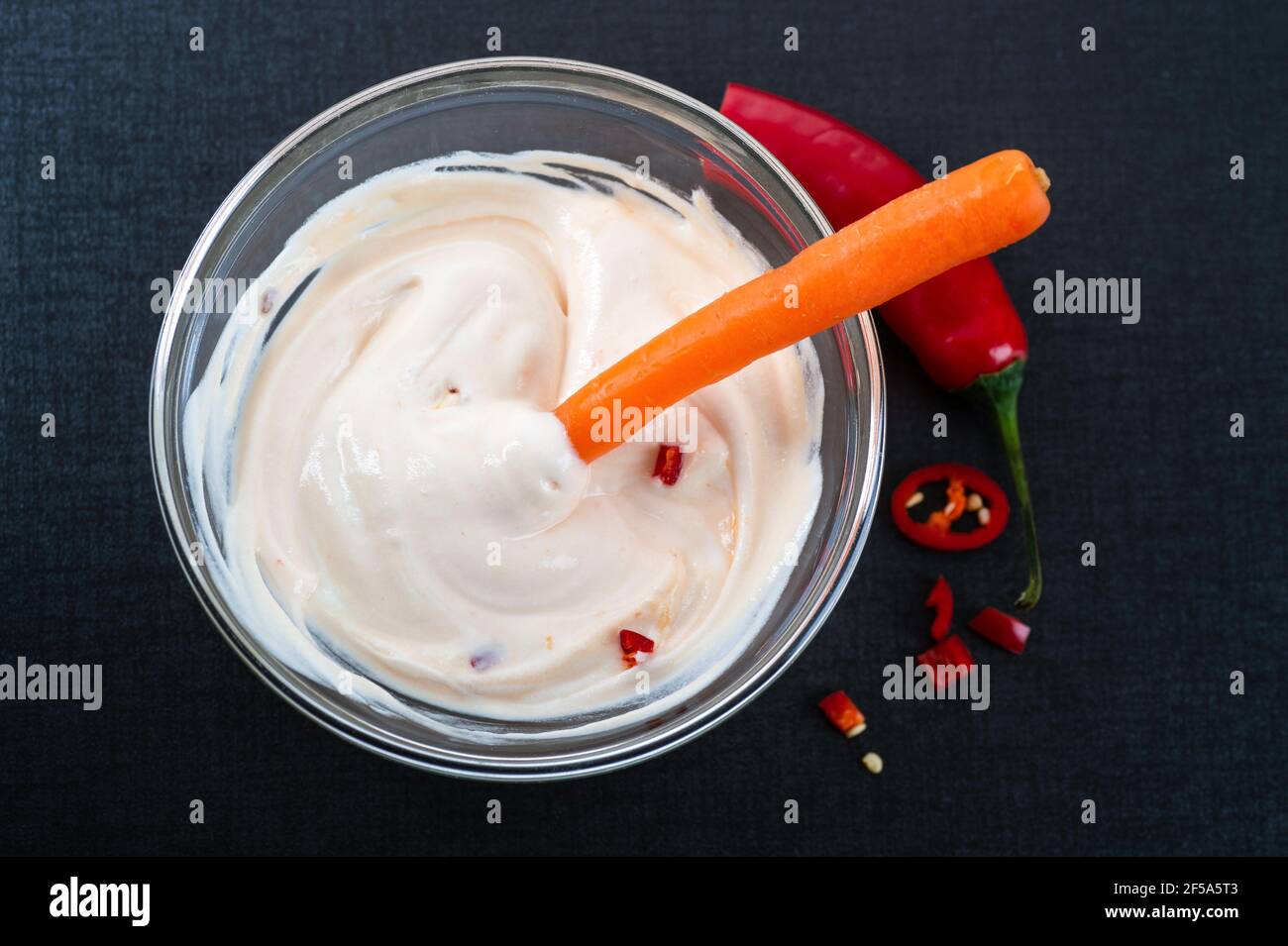 Organic snack carrot with fresh chili and taco sauce in creme fraiche. Stock Photo