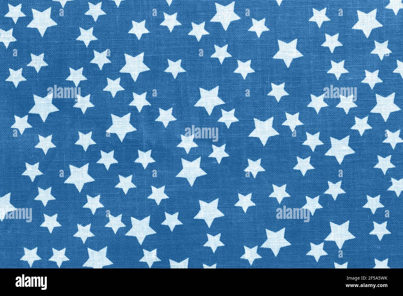 White stars on classic blue canvas cotton texture. Bright colored fabric background Stock Photo