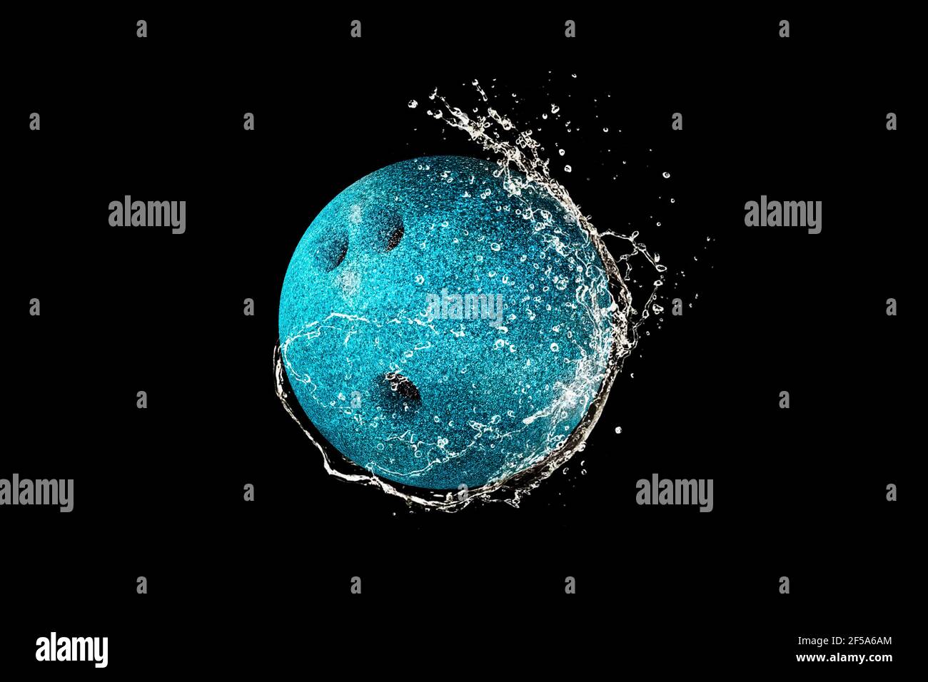 Bowling ball in water drops and splashes isolated on black background Stock Photo