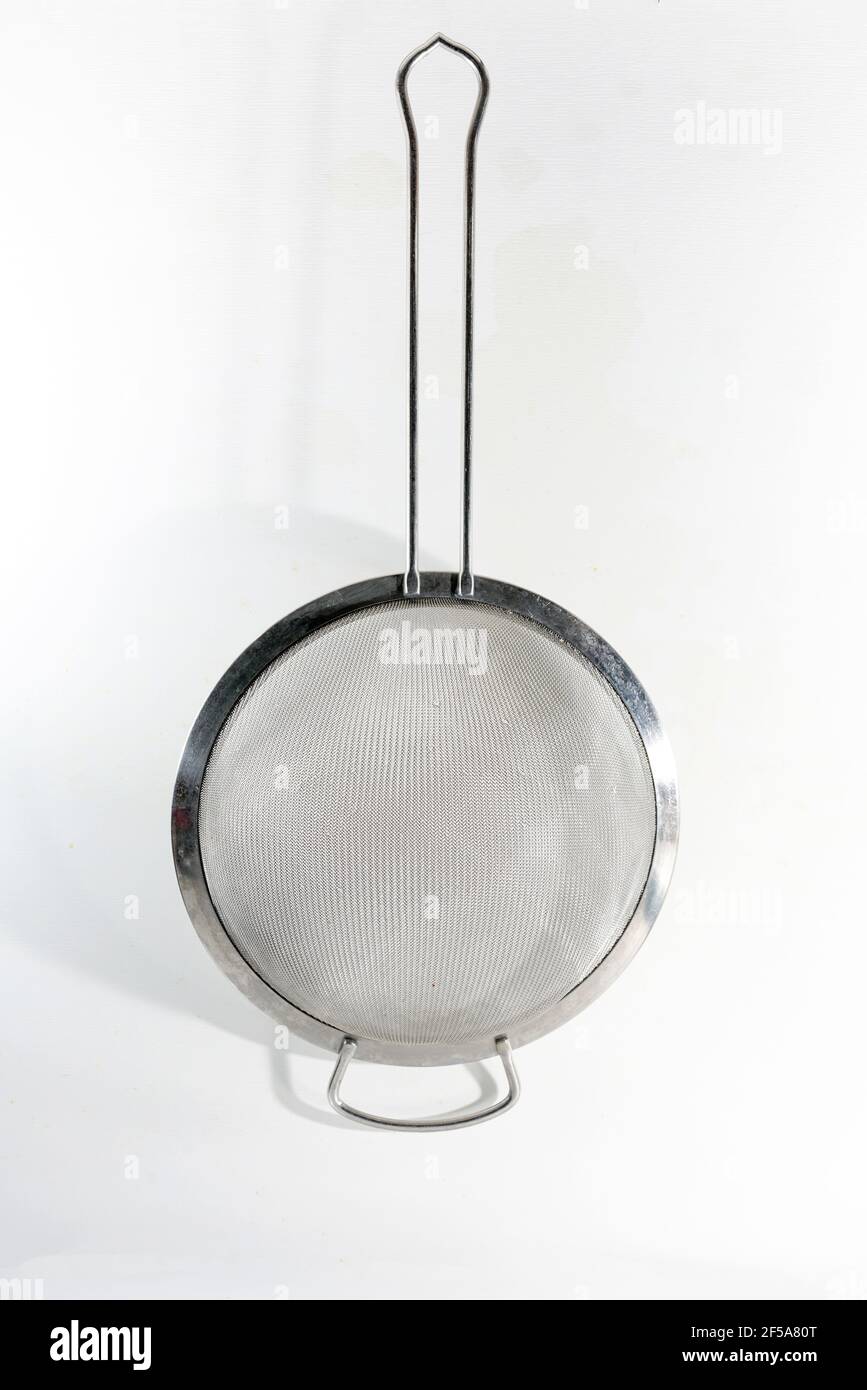Vertical stainless steel fine mesh strainer isolated on white Stock