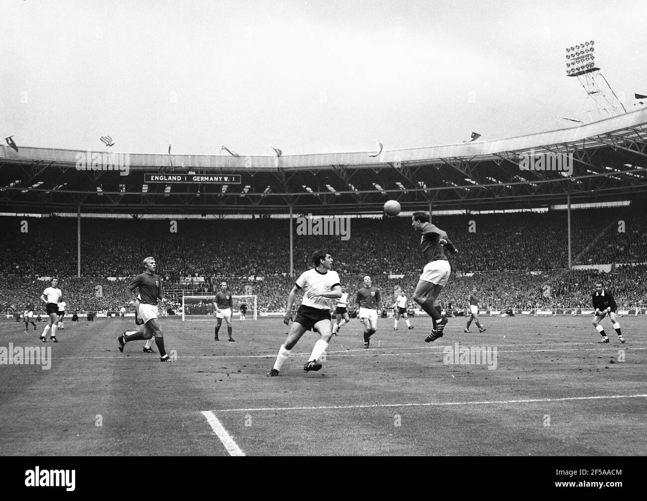 England versus West Germany 1966 World Cup Final, Wembley Stadium 20th minute of the first half.  Ray Wilson of England heads the ball to Captain Bobby Moore past Lothar Emmerich of West Germany  Photo by Tony Henshaw Archive Stock Photo