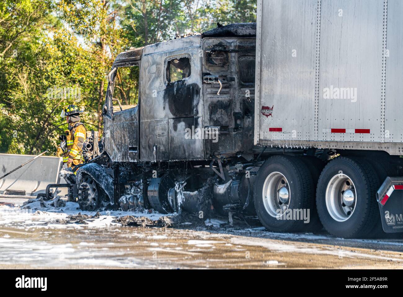 Firefighter at the scene of a semi truck fire on I-95 in downtown Jacksonville, Florida. (USA) Stock Photo