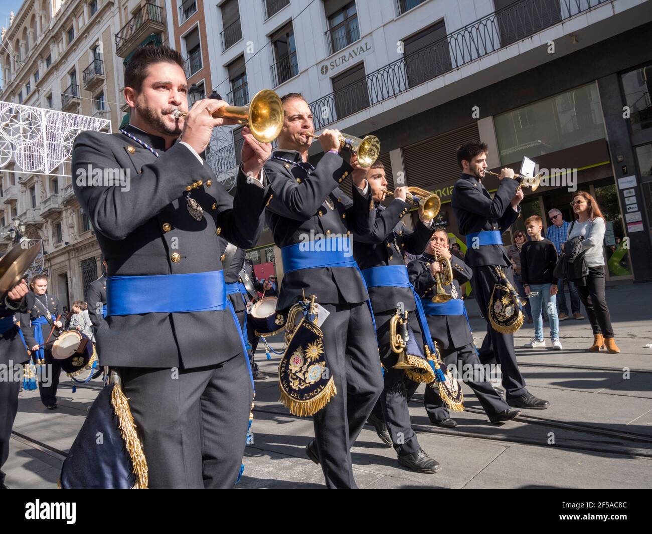 Uniformed members of brass bands clubs take part in a parade and