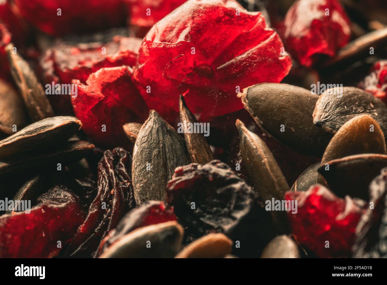 Dried fruits with nuts. Cashew, hazelnuts, peanuts, dried apricots, viburnum, raisins. Stock Photo