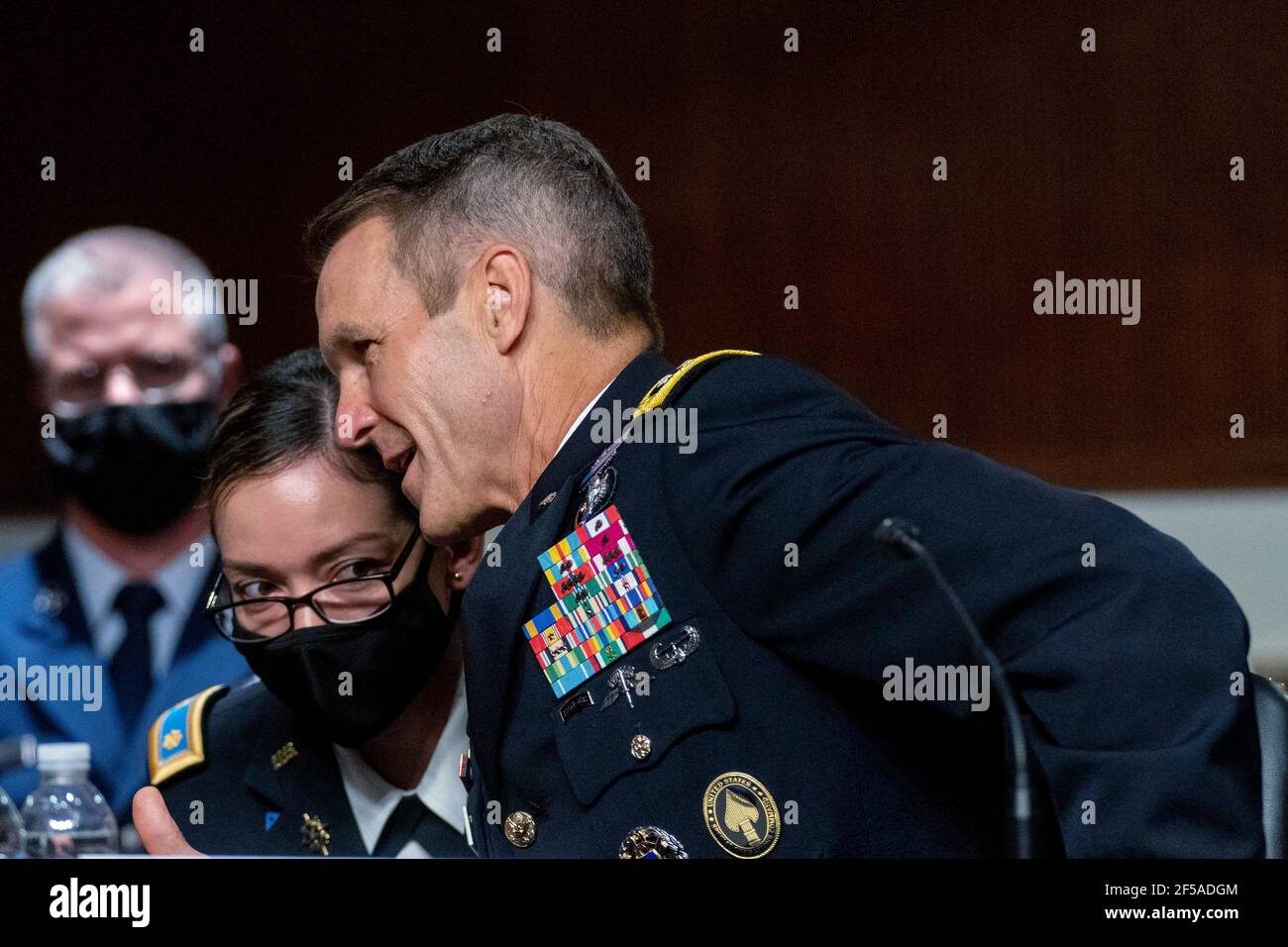 Washington, USA. 25th Mar, 2021. Special Operations Command Gen. Richard Clarke speaks with an aide during a hearing to examine United States Special Operations Command and United States Cyber Command in review of the Defense Authorization Request for fiscal year 2022 and the Future Years Defense Program, on Capitol Hill, Thursday, March 25, 2021, in Washington. (Photo by Andrew Harnik/Pool/Sipa USA) Credit: Sipa USA/Alamy Live News Stock Photo