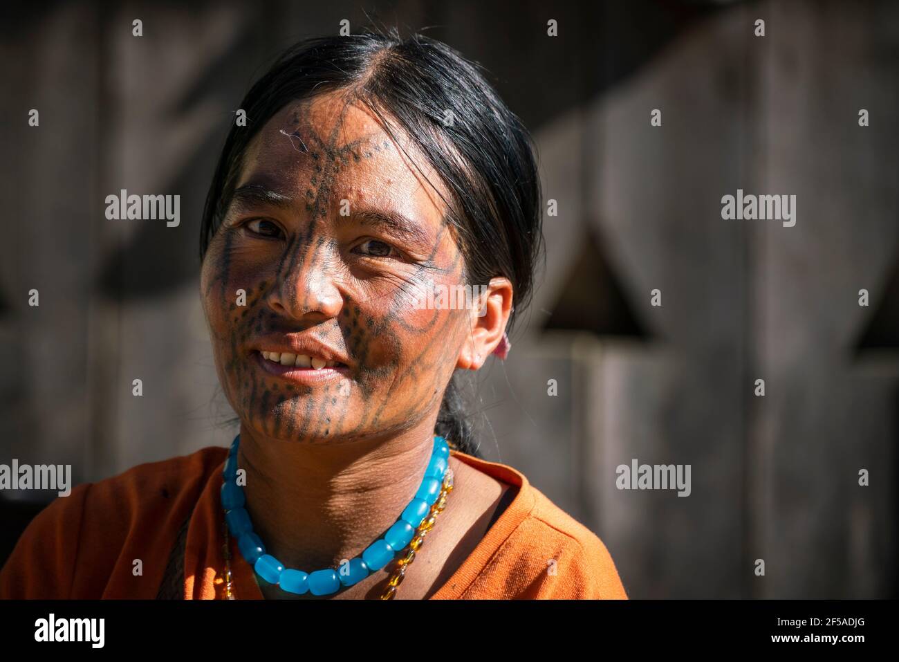 Young smiling woman with traditional facial tattoo, Mindat, Myanmar Stock Photo