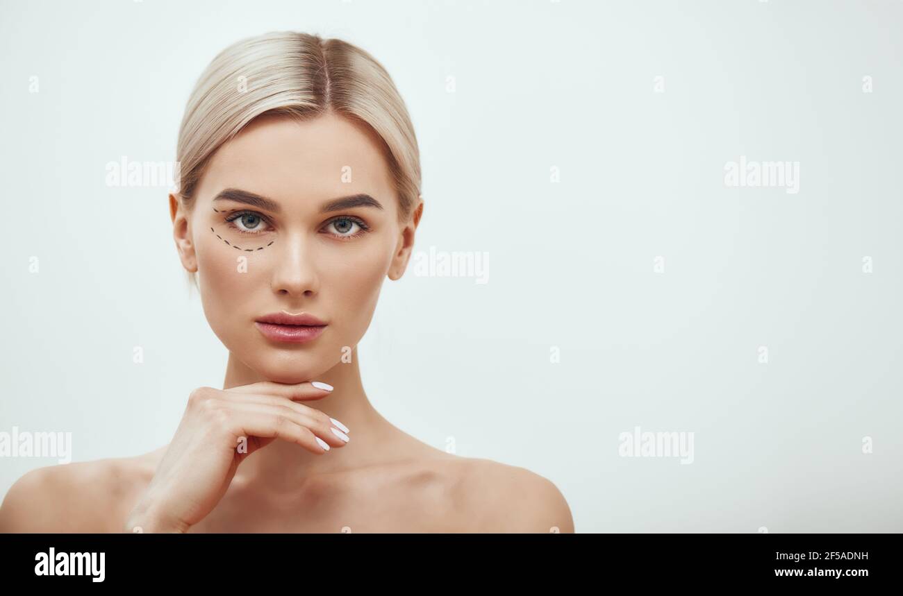 Perforation lines. Beautiful and young blonde woman with black surgical