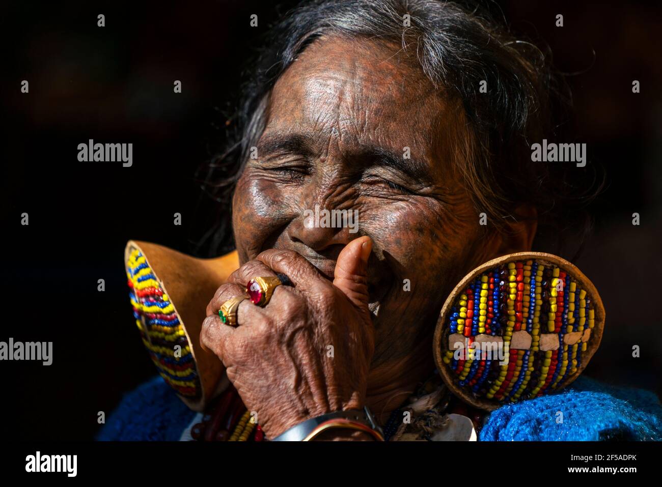 Senior woman with traditional facial tattoo laughing, Mindat, Myanmar Stock Photo