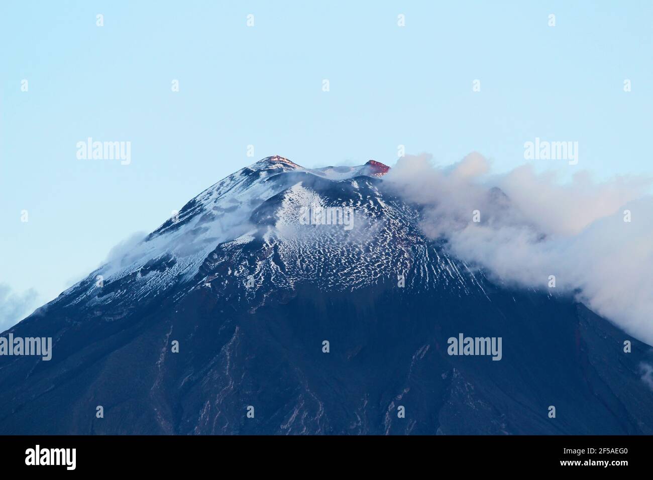 Tungurahua Volcano Summit with Snow at Dusk Stock Photo