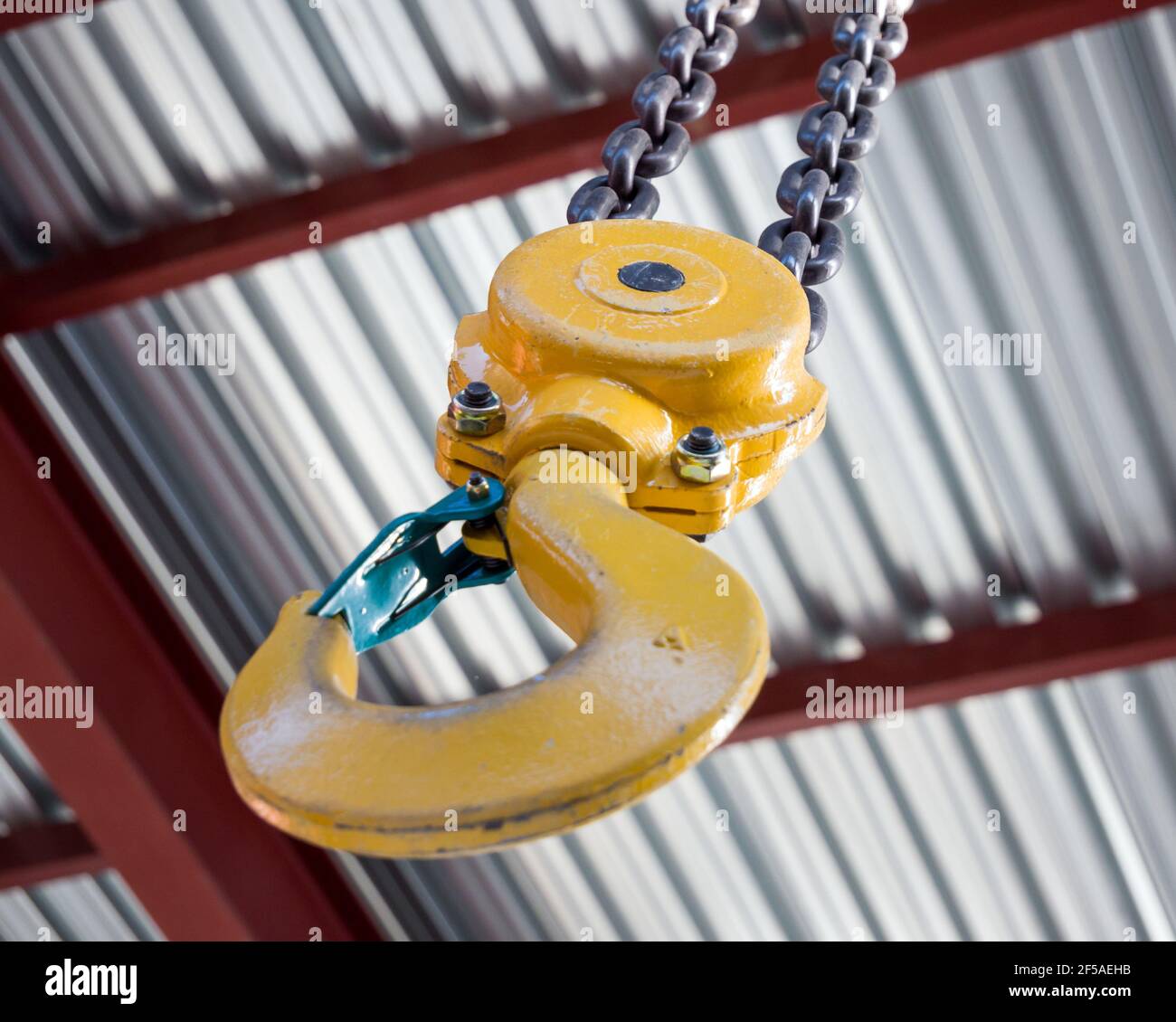 Hand loader hook under hangar ceiling Stock Photo