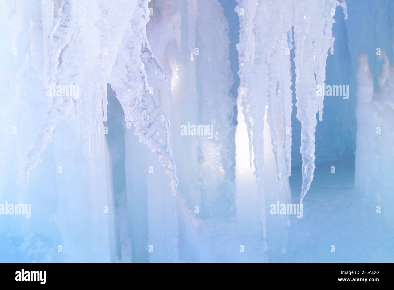 Ice passages in the rocks with large icicles Stock Photo