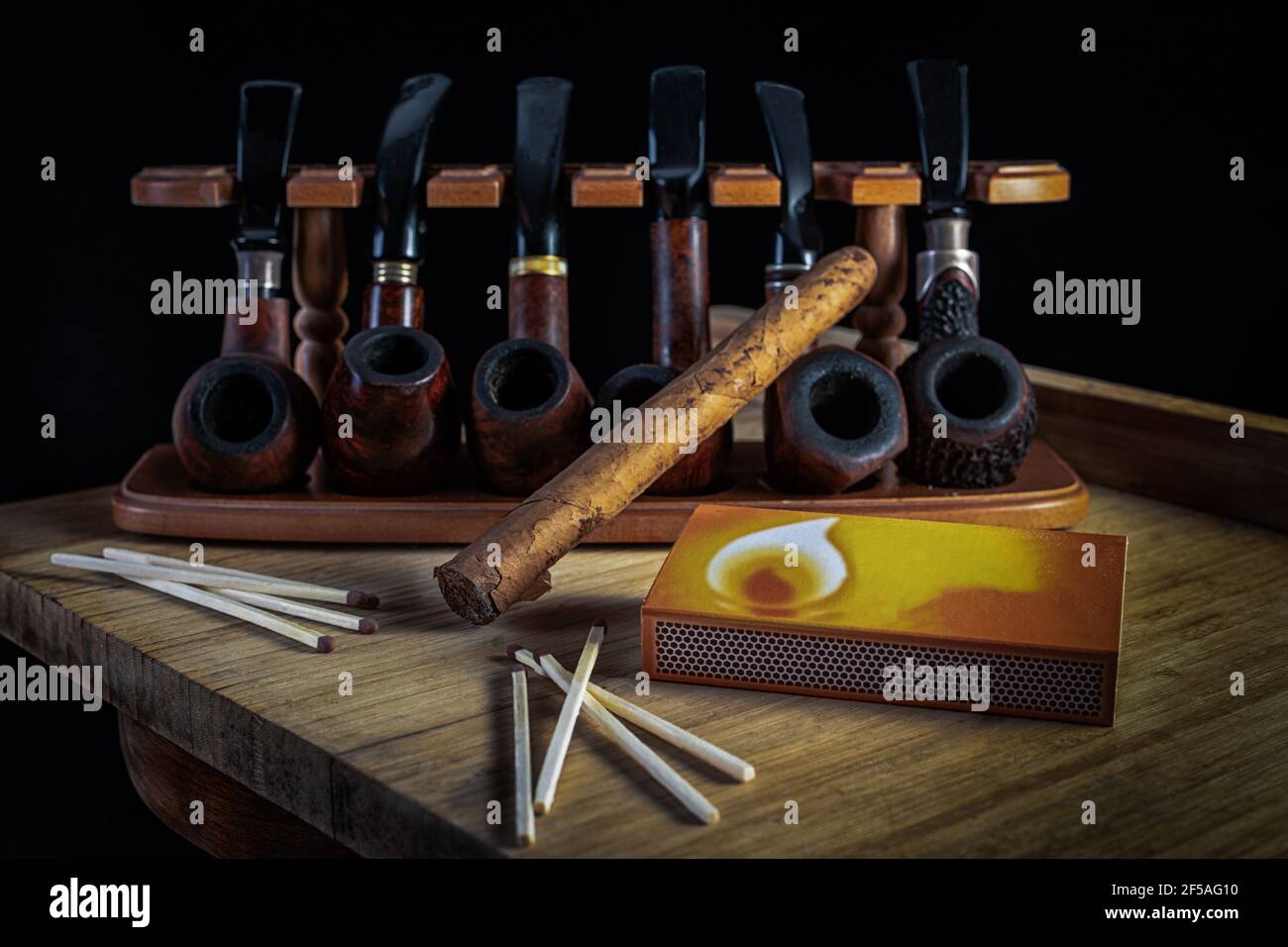 Smoking pipes of different shapes and types in a special rack Stock