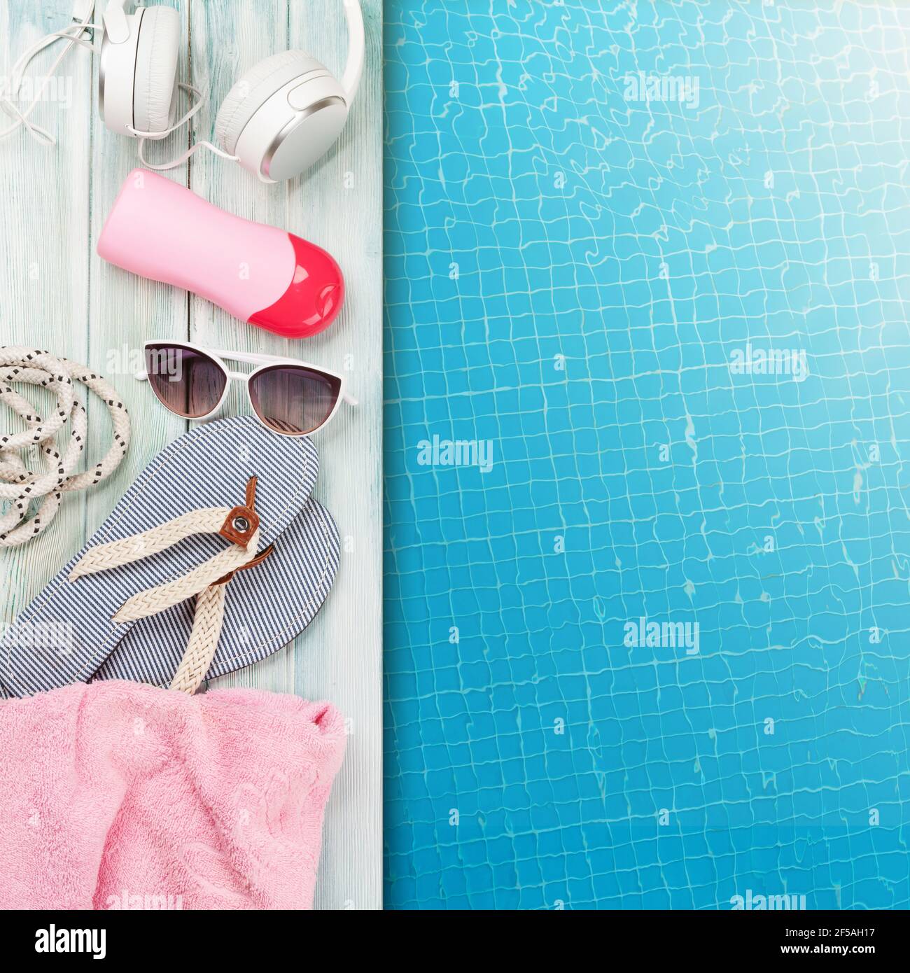 Pool and beach items and water surface of swimming pool. Travel and vacation concept. Top view flat lay with copy space Stock Photo