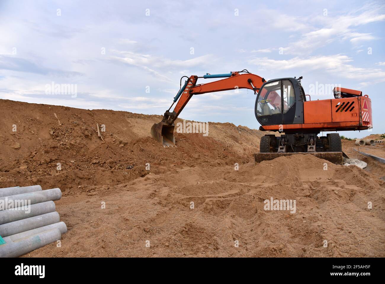Excavator dig the trenches at a construction site. Trench for laying