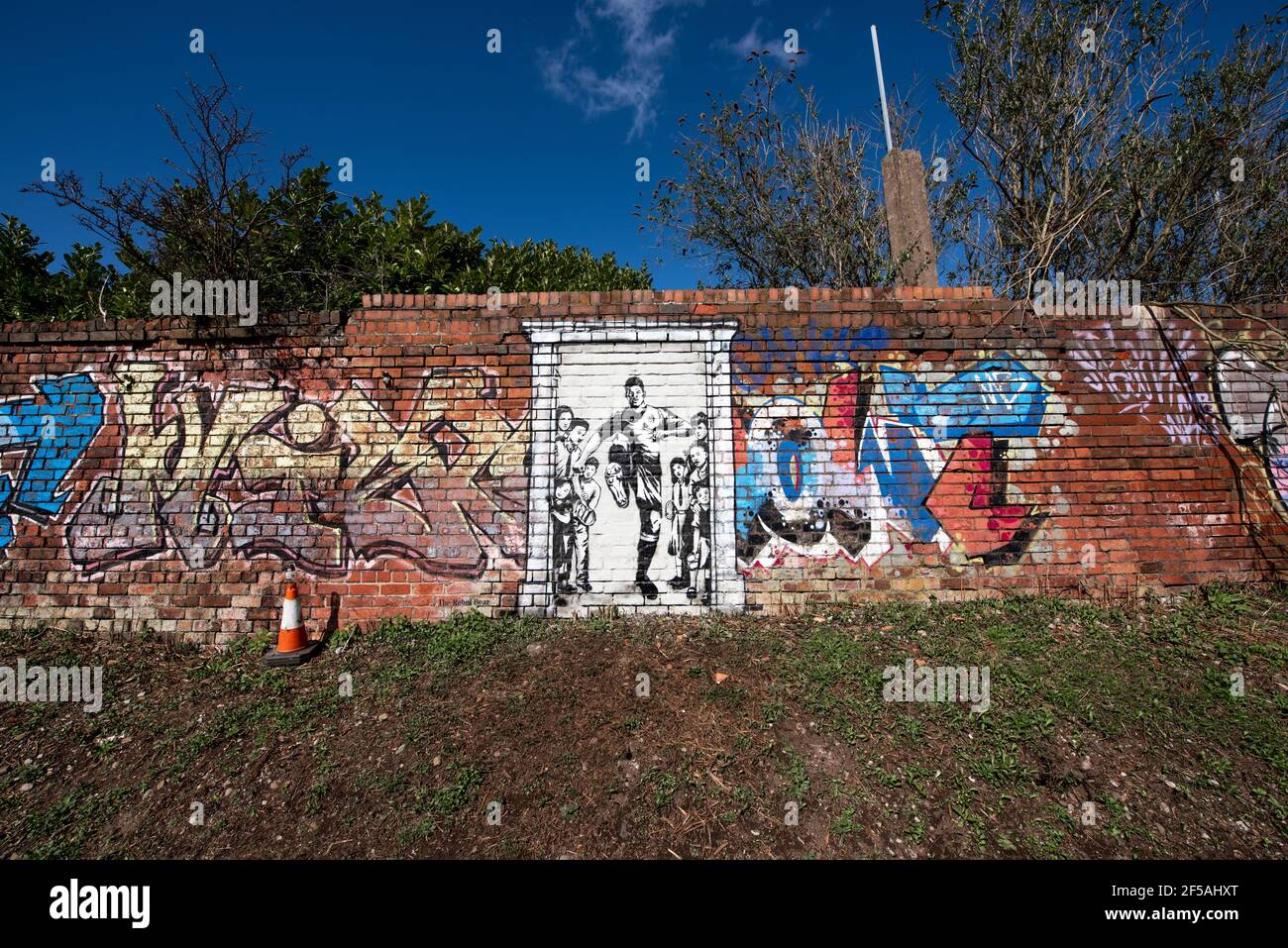 A mural depicting Marcus Rashford kicking down the door to No10 Downing Street. Old Trafford, Manchester, UK. Stock Photo