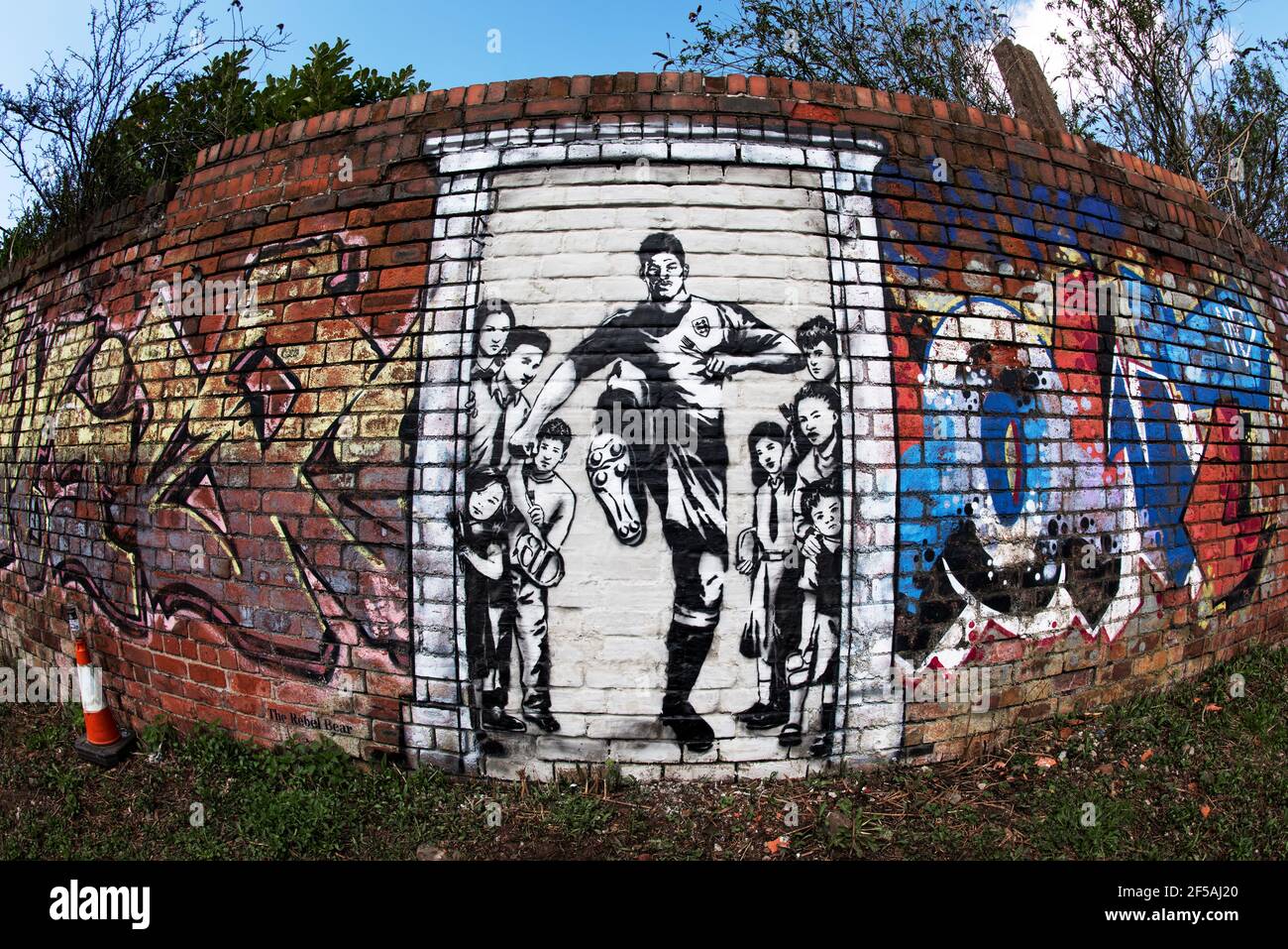 A mural depicting Marcus Rashford kicking down the door to No10 Downing Street. Old Trafford, Manchester, UK. Stock Photo